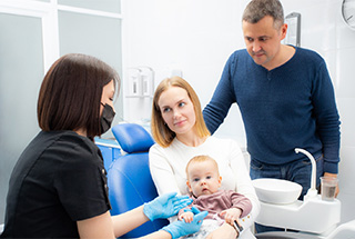 Parents and their baby preparing for lip or tongue tie treatment in McKinney 